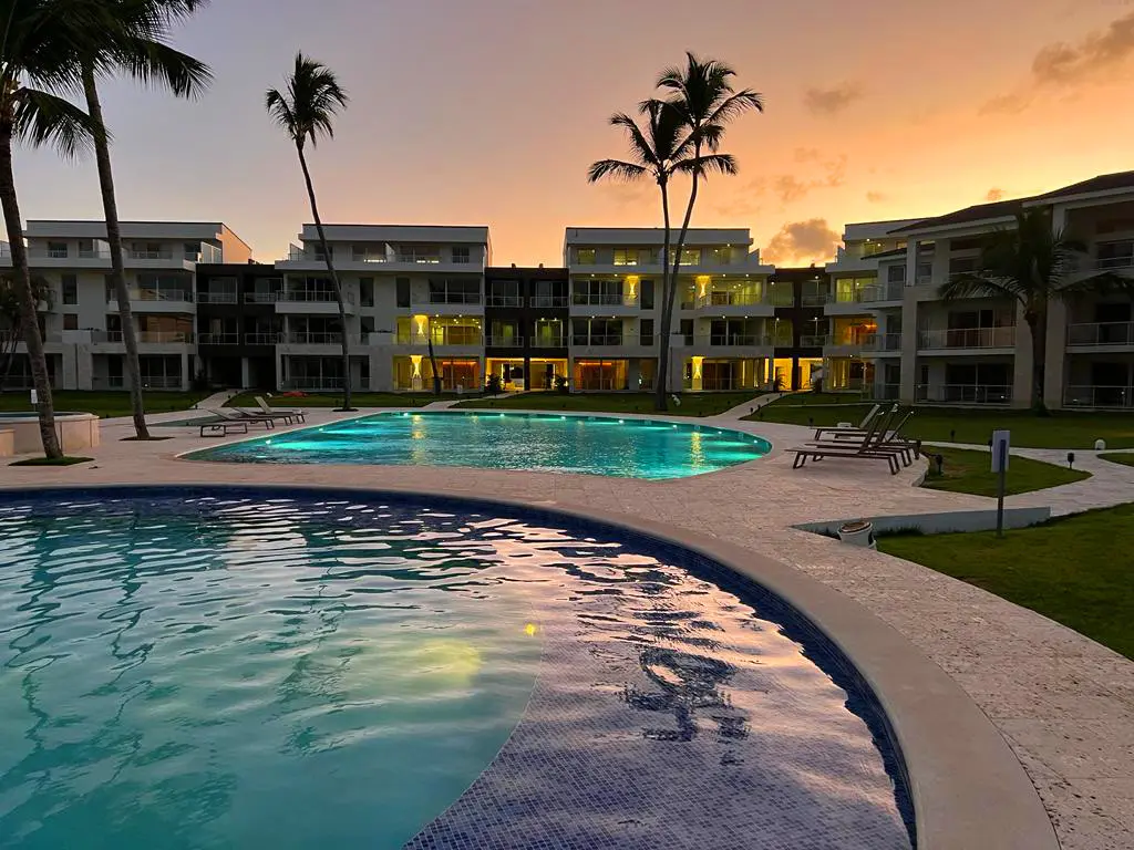 A view of the Ocean View Apartments complex and pools at sunset. 